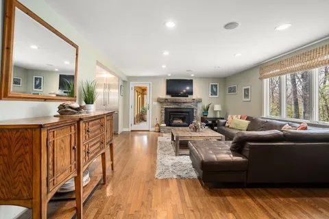 a living room with furniture a fireplace and a flat screen tv