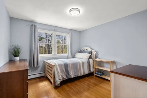 a bedroom with a bed and a potted plant