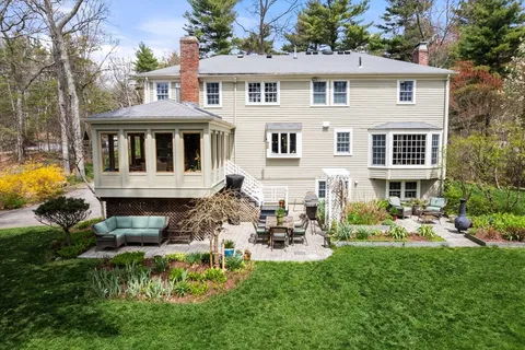 a front view of a house with a yard table and chairs