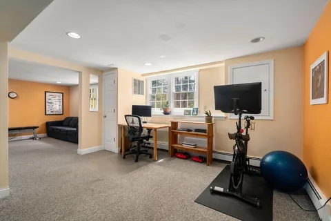 a view of a livingroom with workspace and a window