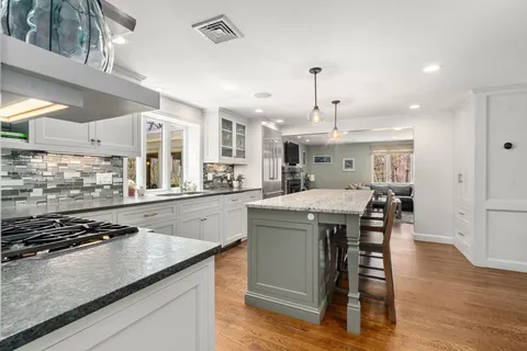 a kitchen with stainless steel appliances granite countertop a stove and a sink