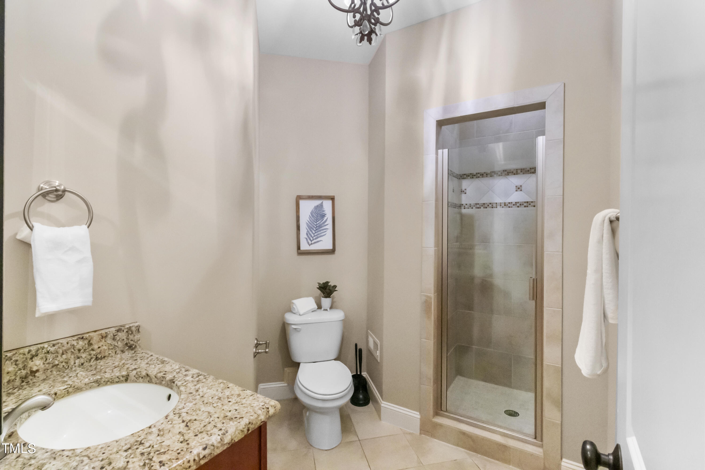 6507 Glendower Road Raleigh, NC 27613 - Photo 14 of 42 a bathroom with a granite countertop sink toilet and shower