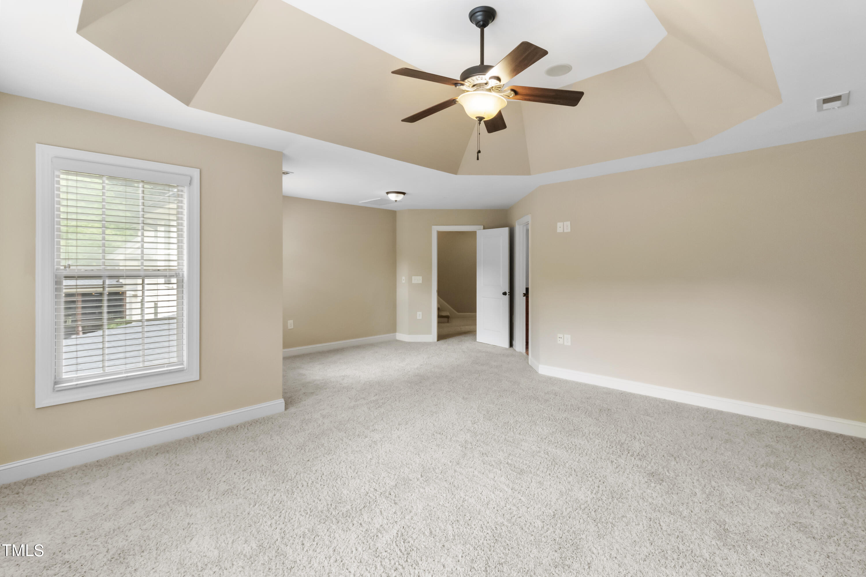 6507 Glendower Road Raleigh, NC 27613 - Photo 19 of 42 an empty room with chandelier fan and windows