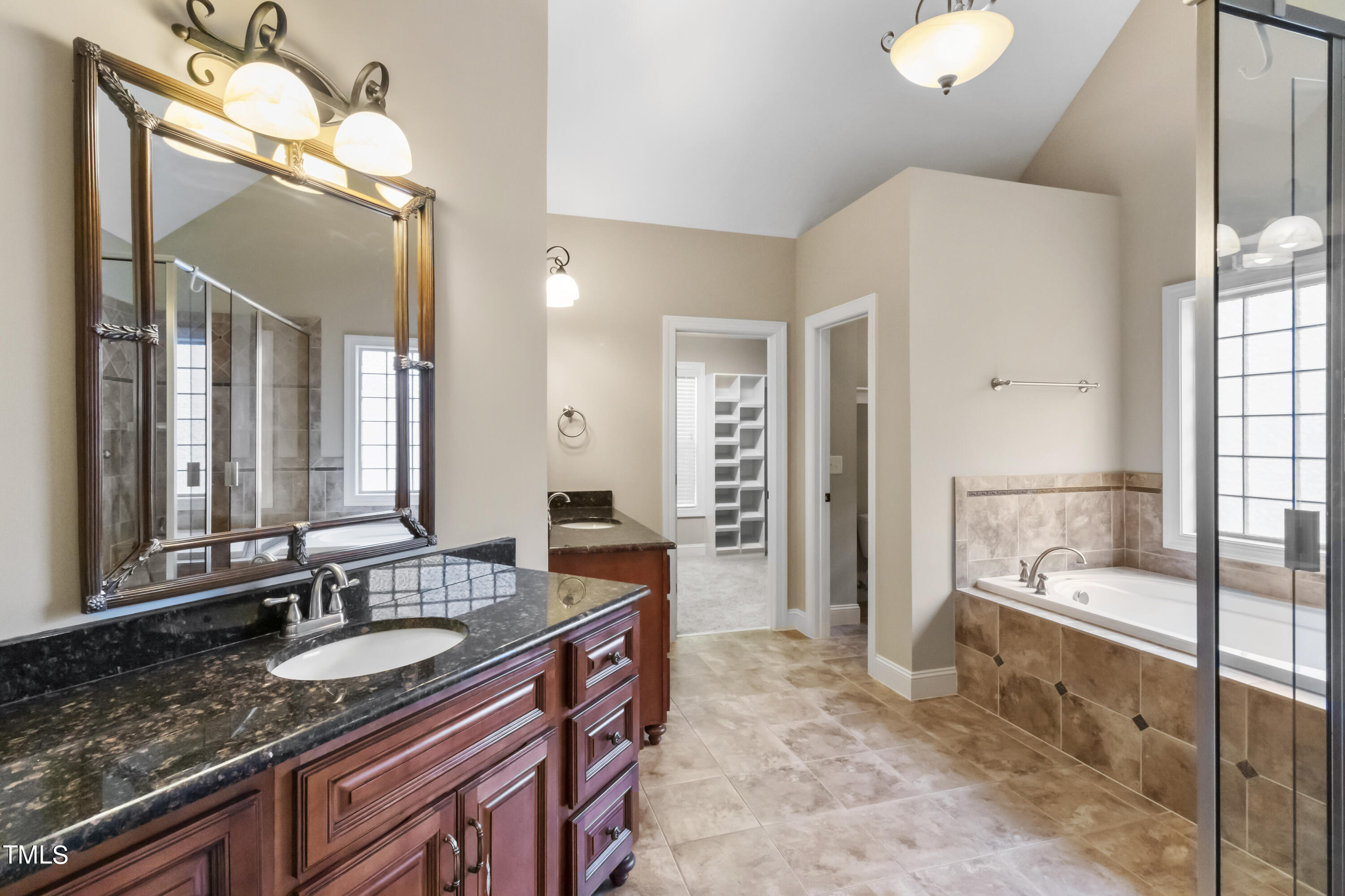 6507 Glendower Road Raleigh, NC 27613 - Photo 20 of 42 a bathroom with a granite countertop sink and a mirror