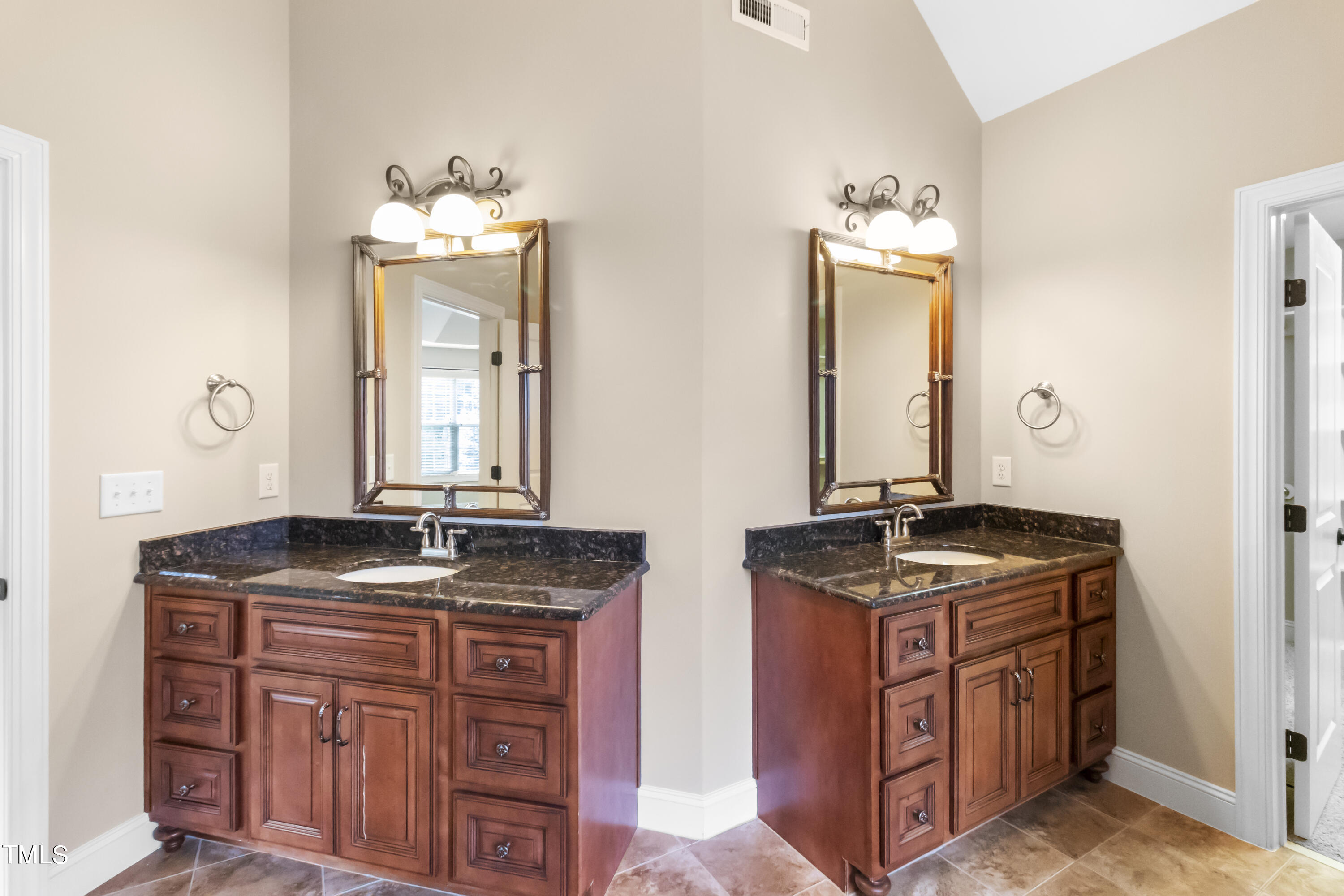 6507 Glendower Road Raleigh, NC 27613 - Photo 21 of 42 a bathroom with a granite countertop double vanity sink and mirror