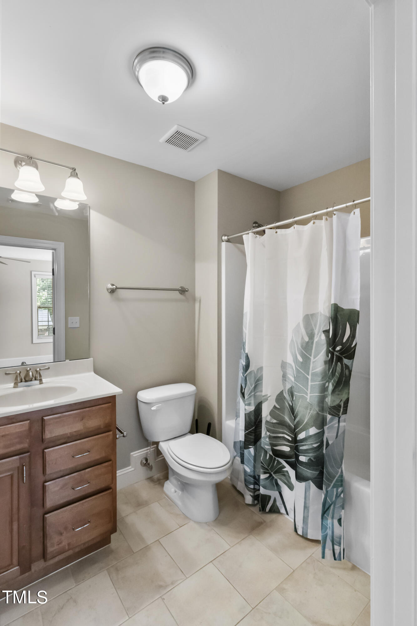 6507 Glendower Road Raleigh, NC 27613 - Photo 26 of 42 a bathroom with a toilet sink and mirror