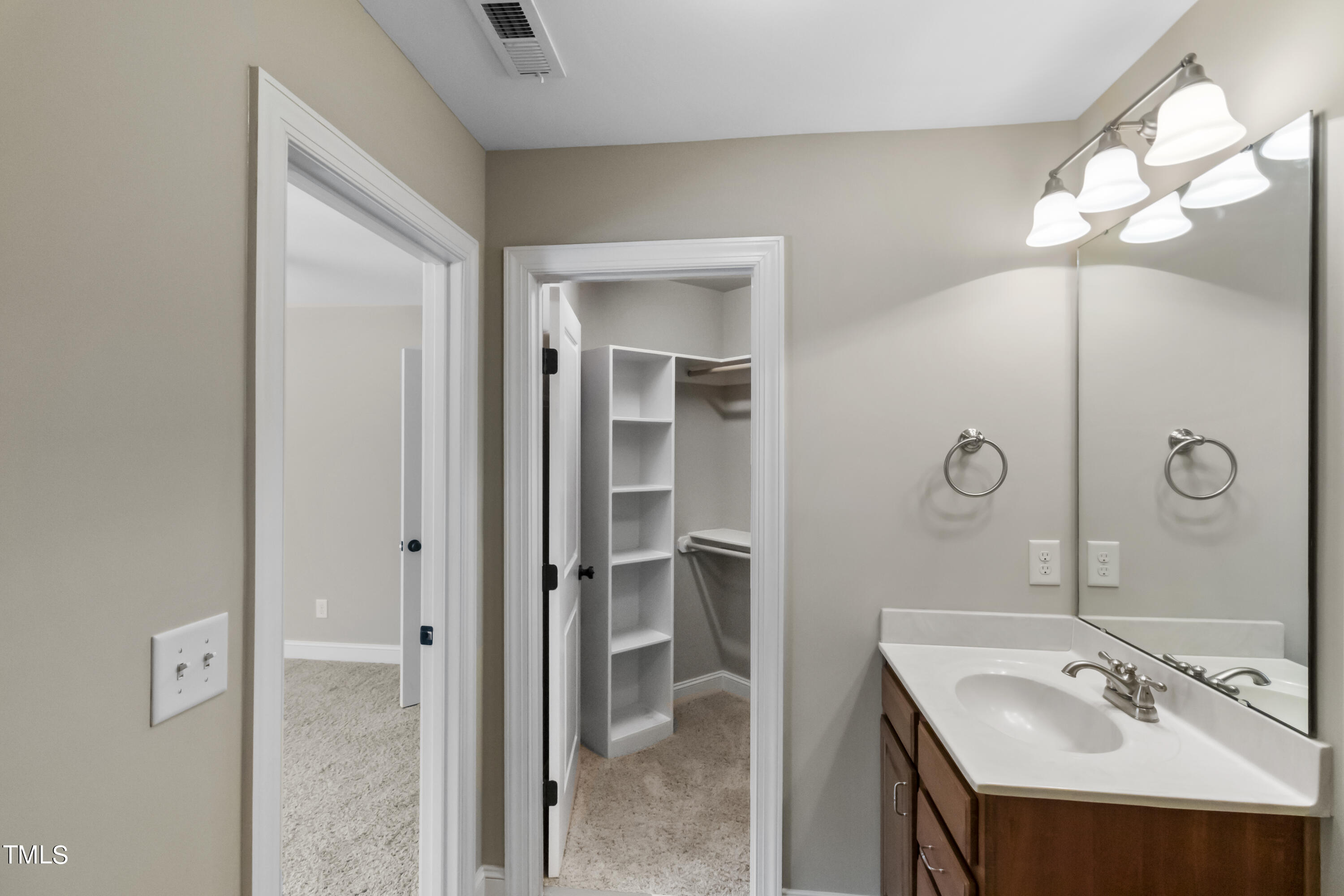 6507 Glendower Road Raleigh, NC 27613 - Photo 27 of 42 a bathroom with a sink vanity and a mirror