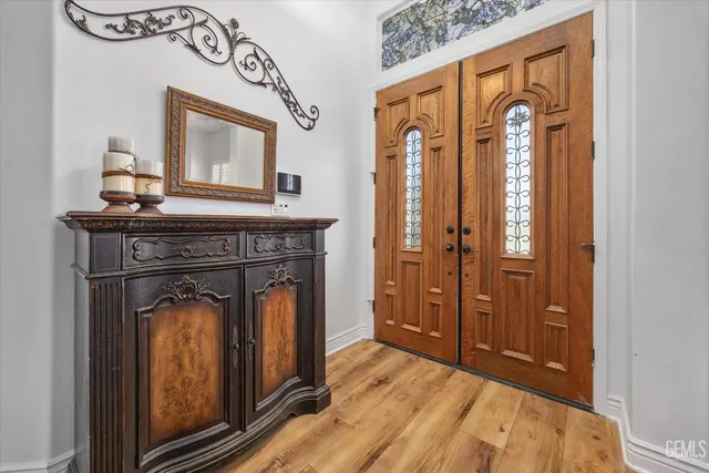 a living room with furniture a clock and a large window