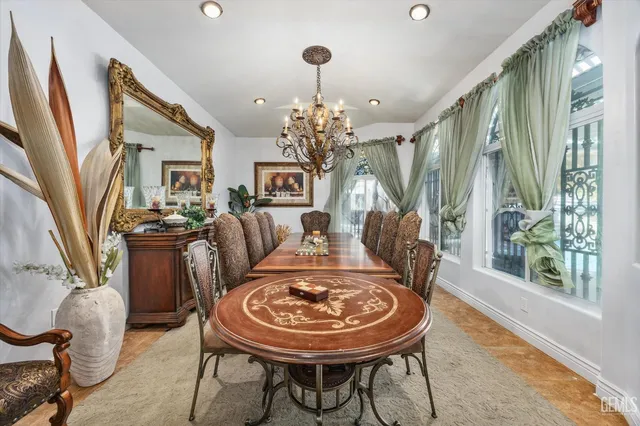 a dining table with stainless steel appliances kitchen island granite countertop a table and chairs