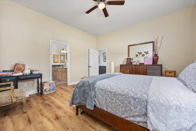 a bathroom with a granite countertop sink a toilet and a mirror
