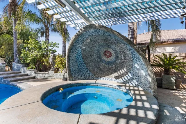 a swimming pool with outdoor seating and yard