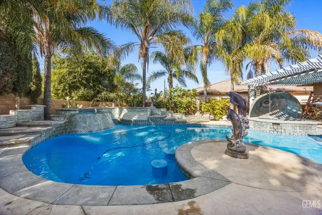 a view of a house with swimming pool and sitting area