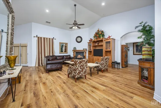 a living room with fireplace furniture and a chandelier