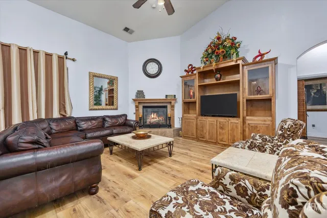 a living room with furniture fireplace and flat screen tv