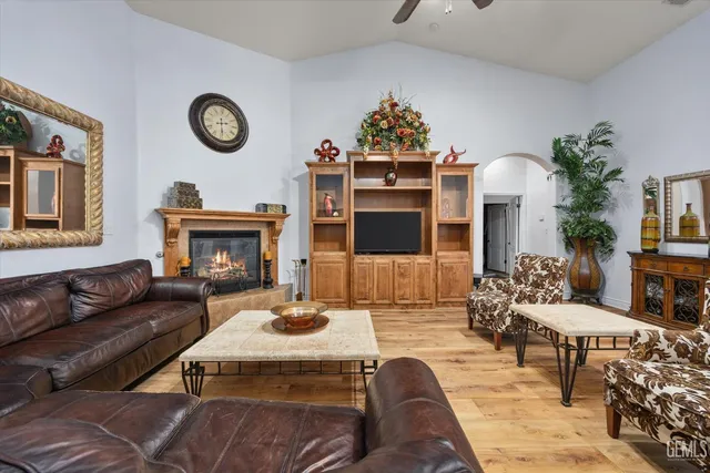 a living room with furniture a clock and a fireplace