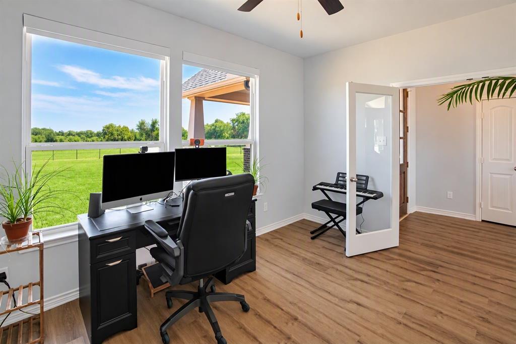 475 Massey Road Gunter, TX 75058 - Photo 23 of 34 Wood-finish flooring, white trim, and light gray wall paint