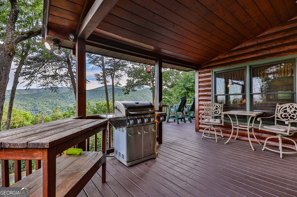 175 Cochise Road, Unit 19 Cherry Log, GA 30522 - Photo 41 of 89 a view of a patio with a table chairs and wooden floor