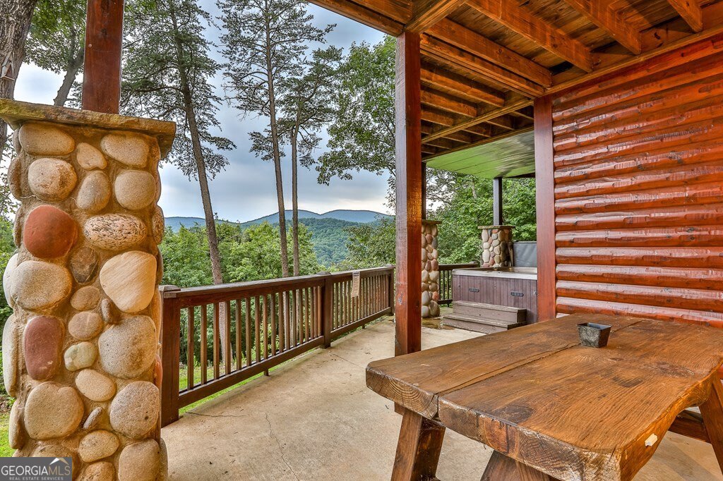 175 Cochise Road, Unit 19 Cherry Log, GA 30522 - Photo 82 of 89 a view of a patio with table and chairs with wooden floor and fence