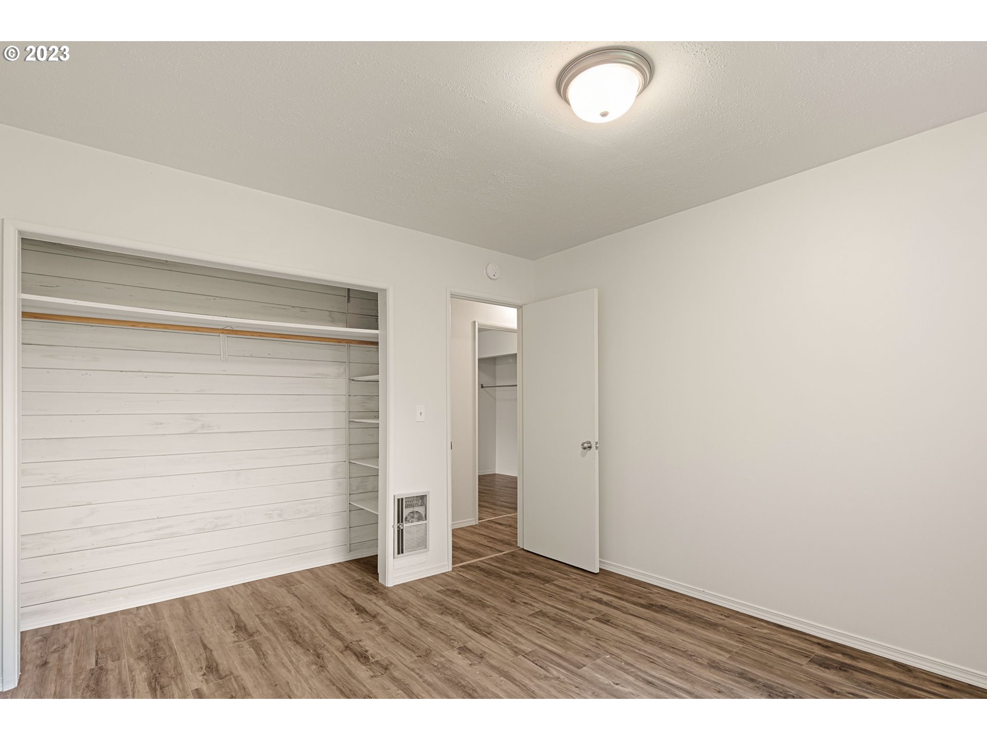 1833 North 12th Street Springfield, OR 97477 - Photo 19 of 37 a view of an empty room with wooden floor and fan