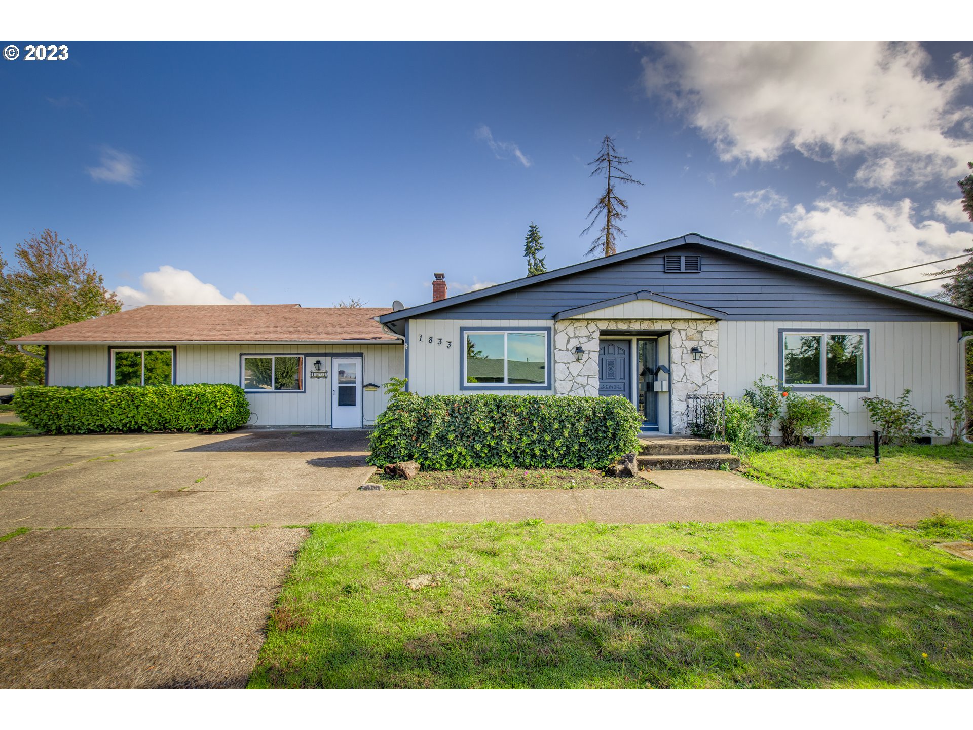 1833 North 12th Street Springfield, OR 97477 - Photo 2 of 37 a front view of a house with yard and green space