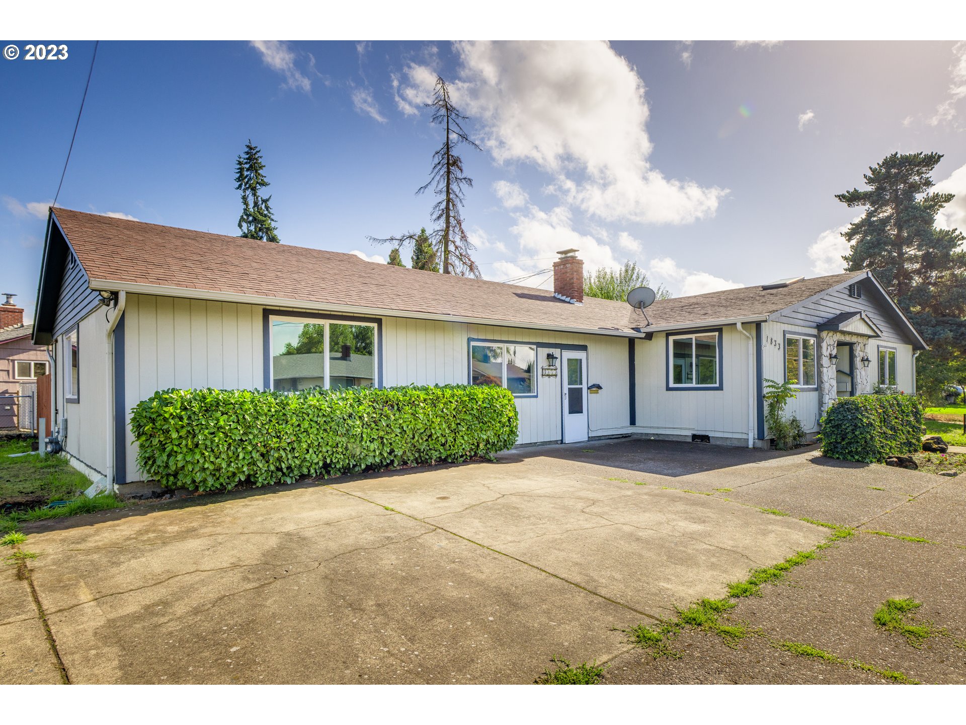 1833 North 12th Street Springfield, OR 97477 - Photo 3 of 37 a front view of a house with a yard and potted plants
