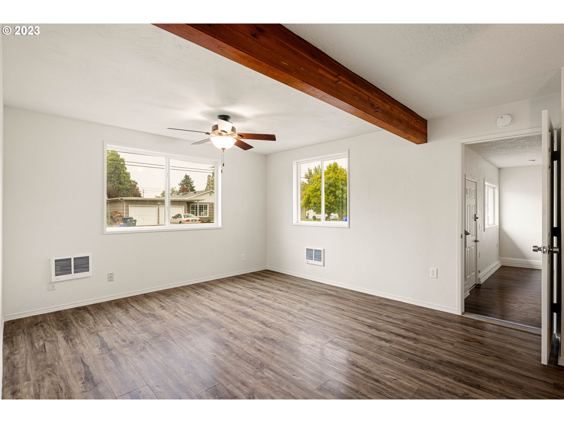 1833 North 12th Street Springfield, OR 97477 - Photo 9 of 37 a view of an empty room with wooden floor and a window