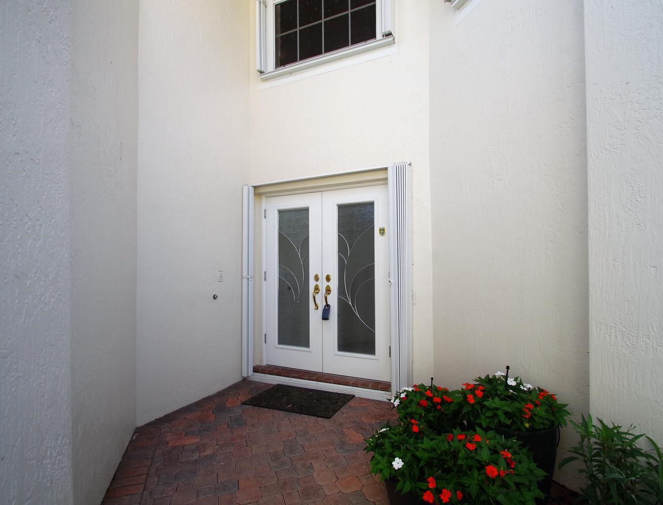 6535 Colomera Drive Boca Raton, FL 33433 - Photo 3 of 36 a view of an entryway with flower pot