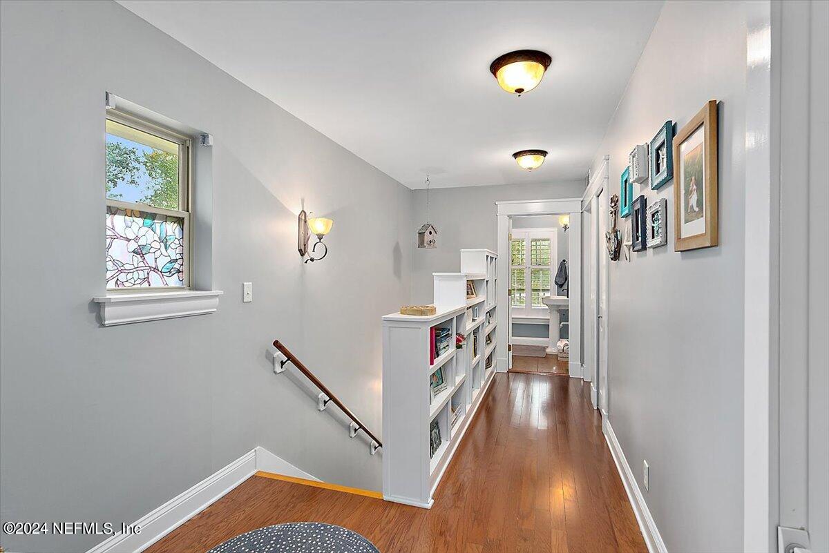 21E Casanova Road St. Augustine, FL 32080 - Photo 11 of 29 a view of a hallway with wooden floor and furniture