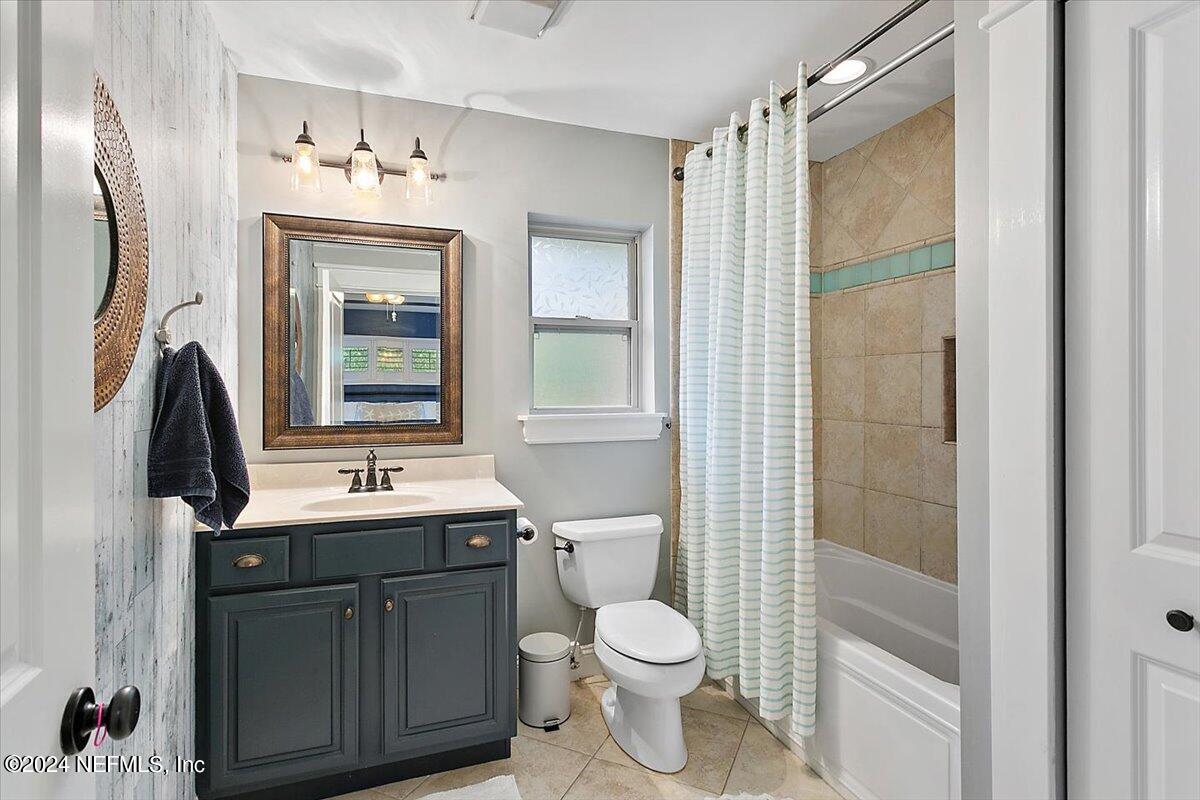 21E Casanova Road St. Augustine, FL 32080 - Photo 13 of 29 a bathroom with a toilet a sink and mirror