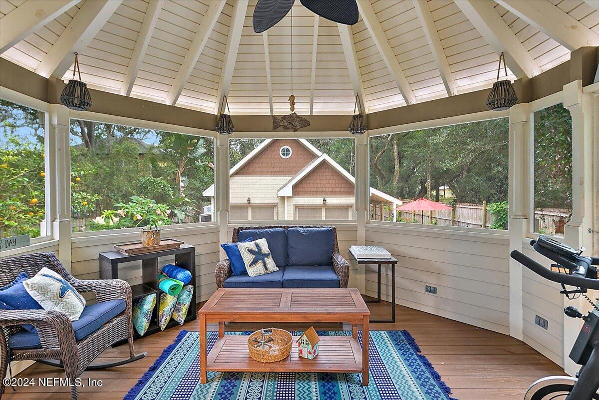 21E Casanova Road St. Augustine, FL 32080 - Photo 20 of 29 a living room with furniture a rug and a floor to ceiling window