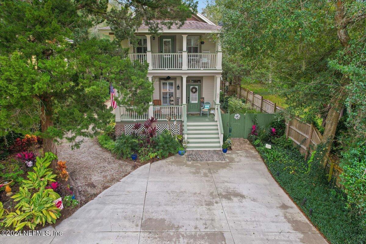 21E Casanova Road St. Augustine, FL 32080 - Photo 26 of 29 a front view of a house with a yard and potted plants