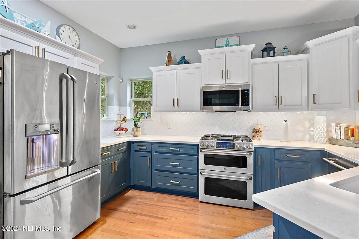 21E Casanova Road St. Augustine, FL 32080 - Photo 7 of 29 a kitchen with stainless steel appliances a stove a sink and a refrigerator