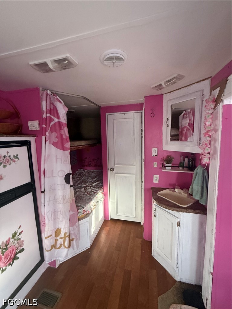 6724 5th Road LaBelle, FL 33935 - Photo 22 of 28 a bedroom with a bed and wooden floor