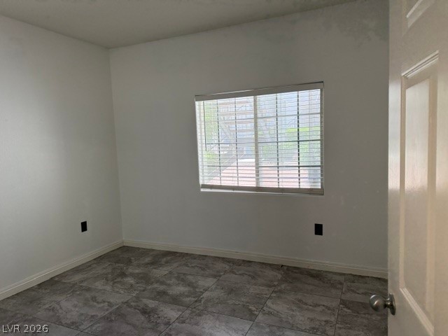 3318 North Decatur Boulevard, Unit 1163 Las Vegas, NV 89130 - Photo 28 of 35 A well-lit bedroom features durable tile flooring and a window with horizontal blinds.