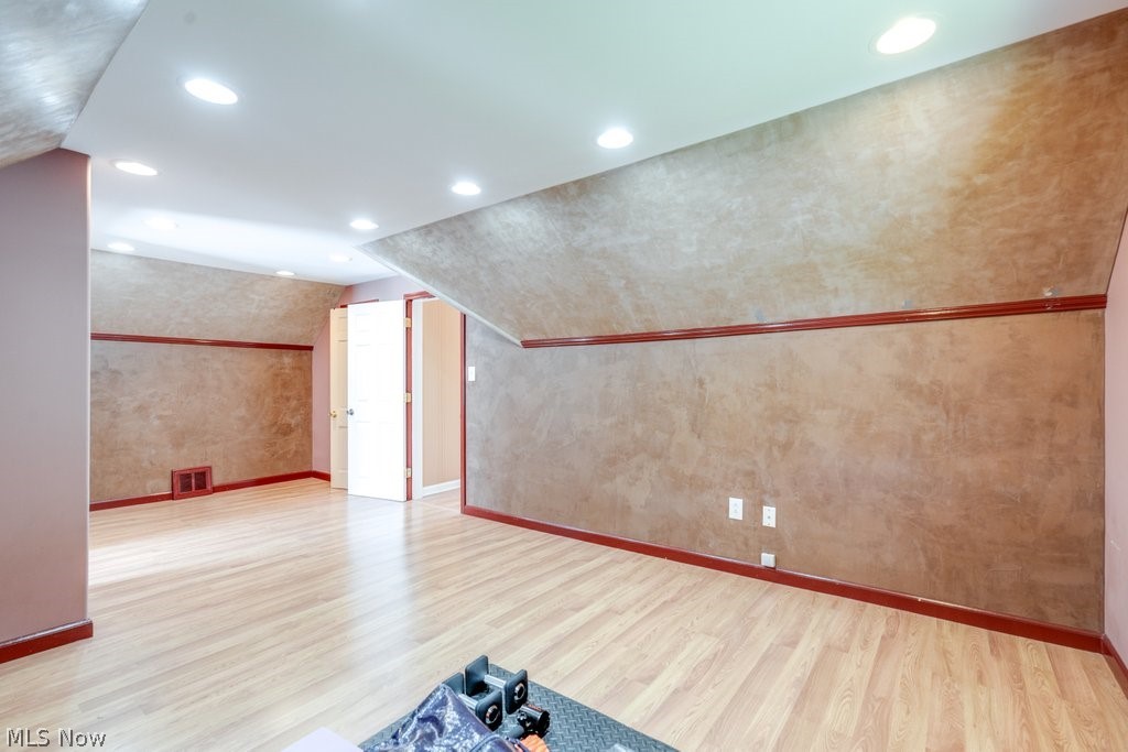 1367 Churchill Road Lyndhurst, OH 44124 - Photo 29 of 30 Spacious room featuring wood-finish flooring, recessed ceiling lighting, and textured wall finishes with dark trim