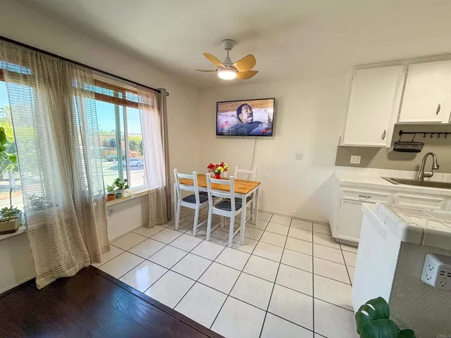 a living room with furniture a rug and a large window