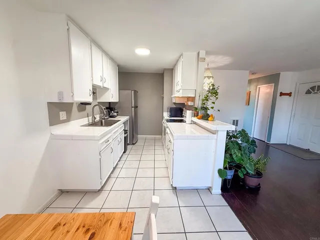a room with a sink furniture and a potted plant