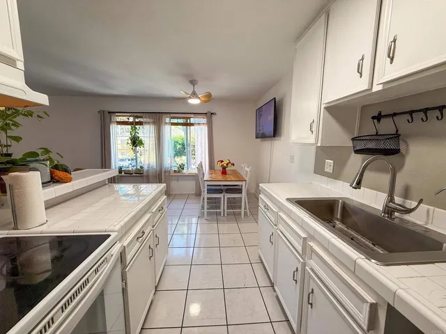 a kitchen with a sink stove top oven and cabinets