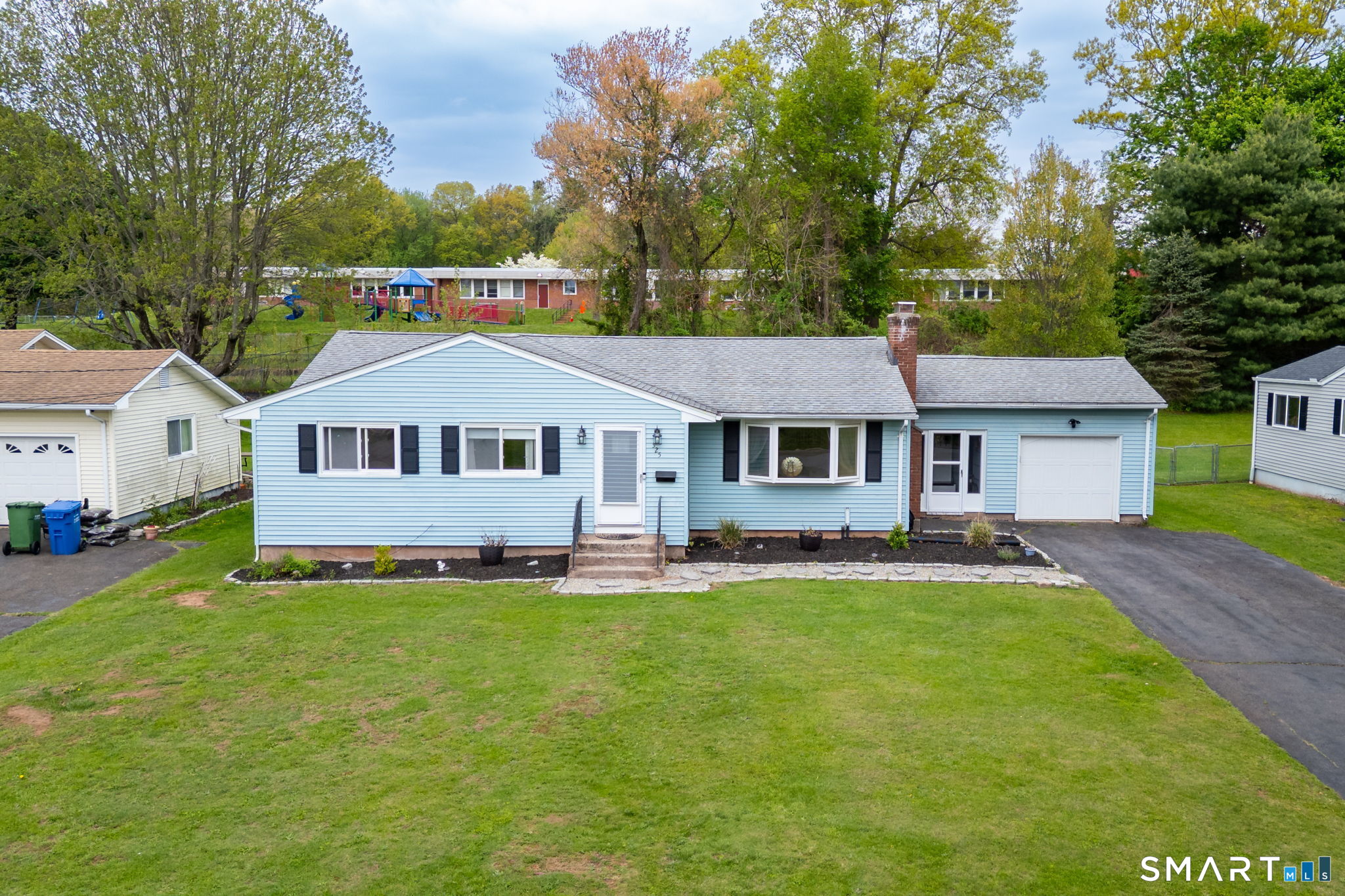 325 Barbara Road Middletown, CT 06457 - Photo 1 of 40 a front view of a house with a garden and trees