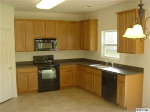 2918 Liddington Road Matthews, NC 28105 - Photo 2 of 6 a kitchen with stainless steel appliances granite countertop a sink a stove and a refrigerator