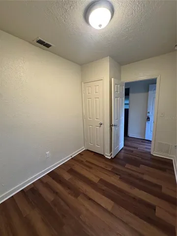 a view of an empty room and wooden floor