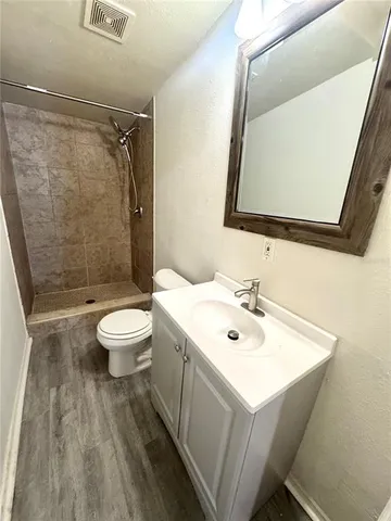 a bathroom with a sink mirror toilet and shower