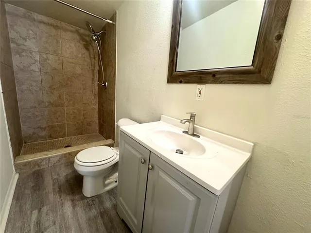 a bathroom with a sink mirror toilet and shower