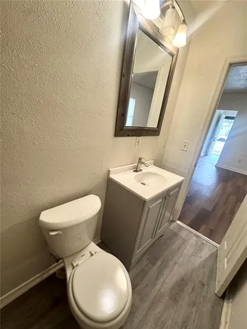 a white toilet sitting next to a bathroom sink