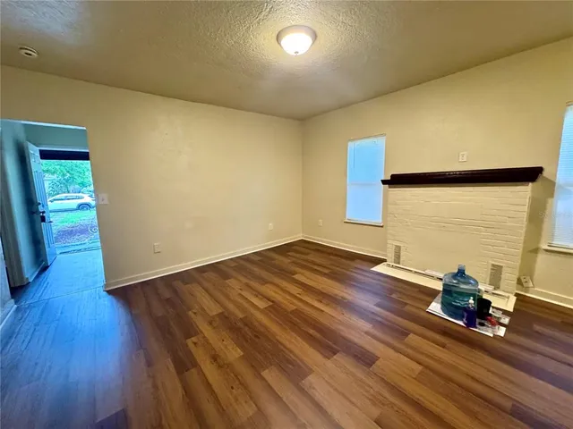 a view of a room with wooden floor and stairs