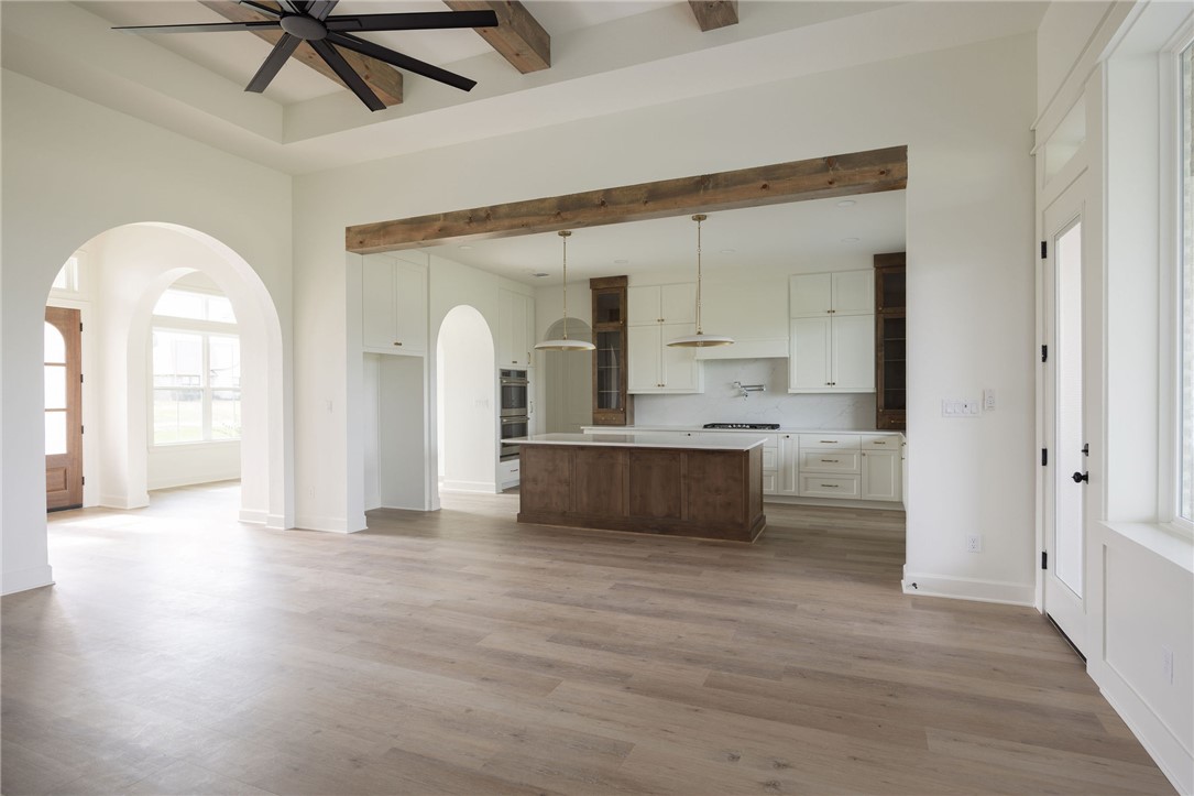 6697 Ridgeview Estates Lane Bryan, TX 77808 - Photo 13 of 31 a view of large windows and a kitchen with wooden floor