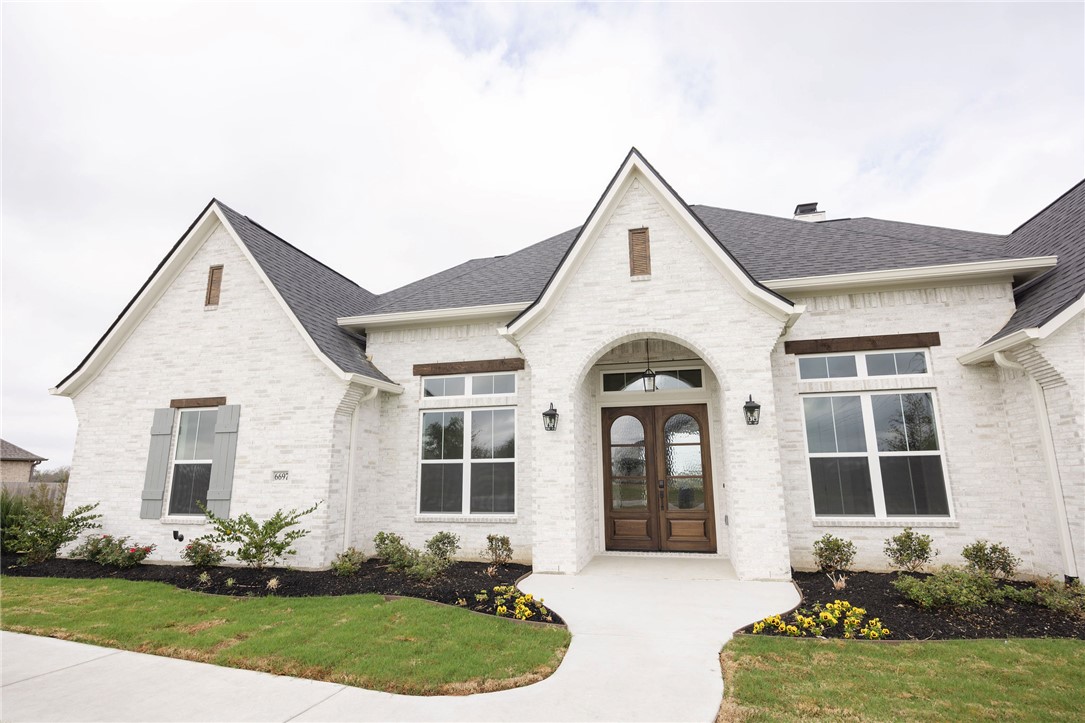 6697 Ridgeview Estates Lane Bryan, TX 77808 - Photo 3 of 31 a front view of a house with a yard