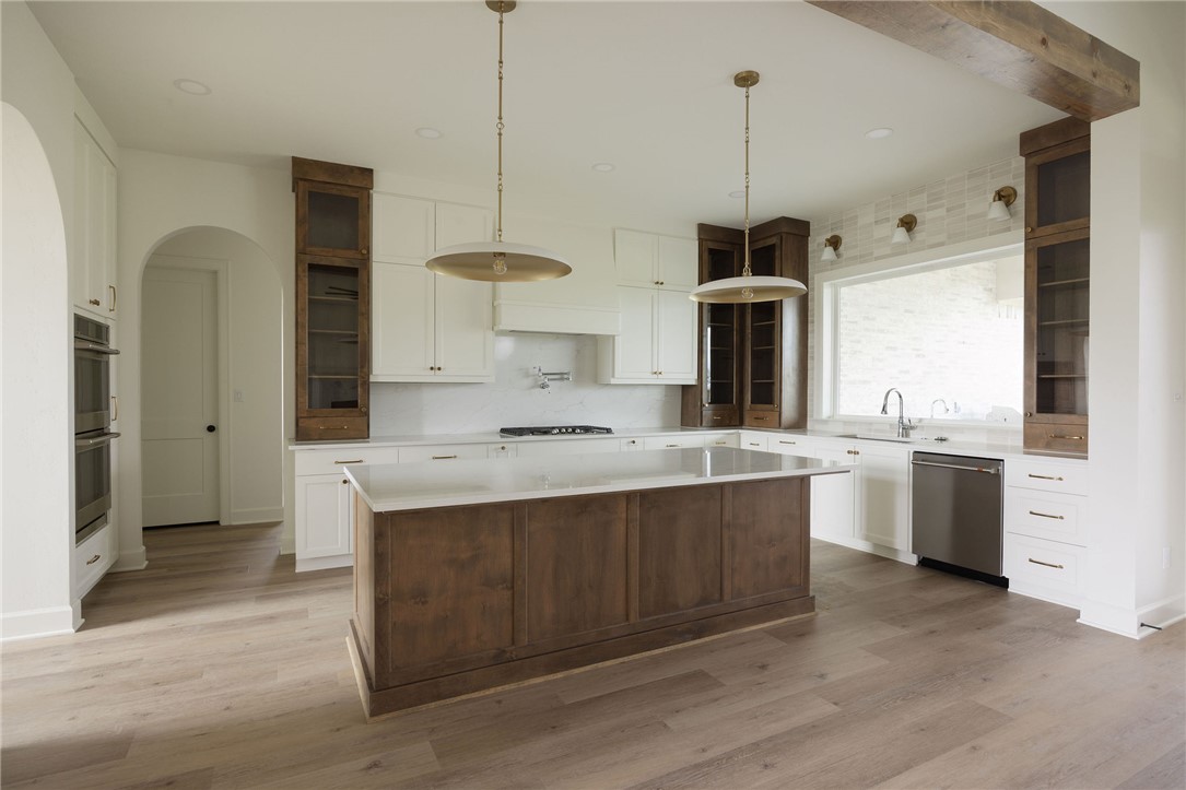 6697 Ridgeview Estates Lane Bryan, TX 77808 - Photo 6 of 31 a kitchen with kitchen island a sink stainless steel appliances and cabinets