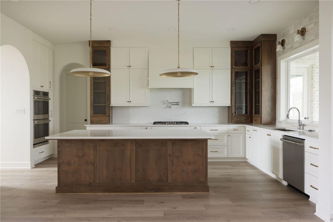 6697 Ridgeview Estates Lane Bryan, TX 77808 - Photo 7 of 31 a kitchen with stainless steel appliances granite countertop a sink a stove and a refrigerator