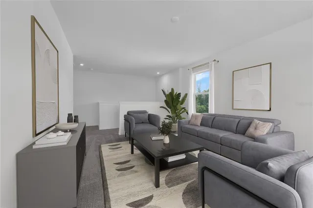 a living room with furniture and a potted plant